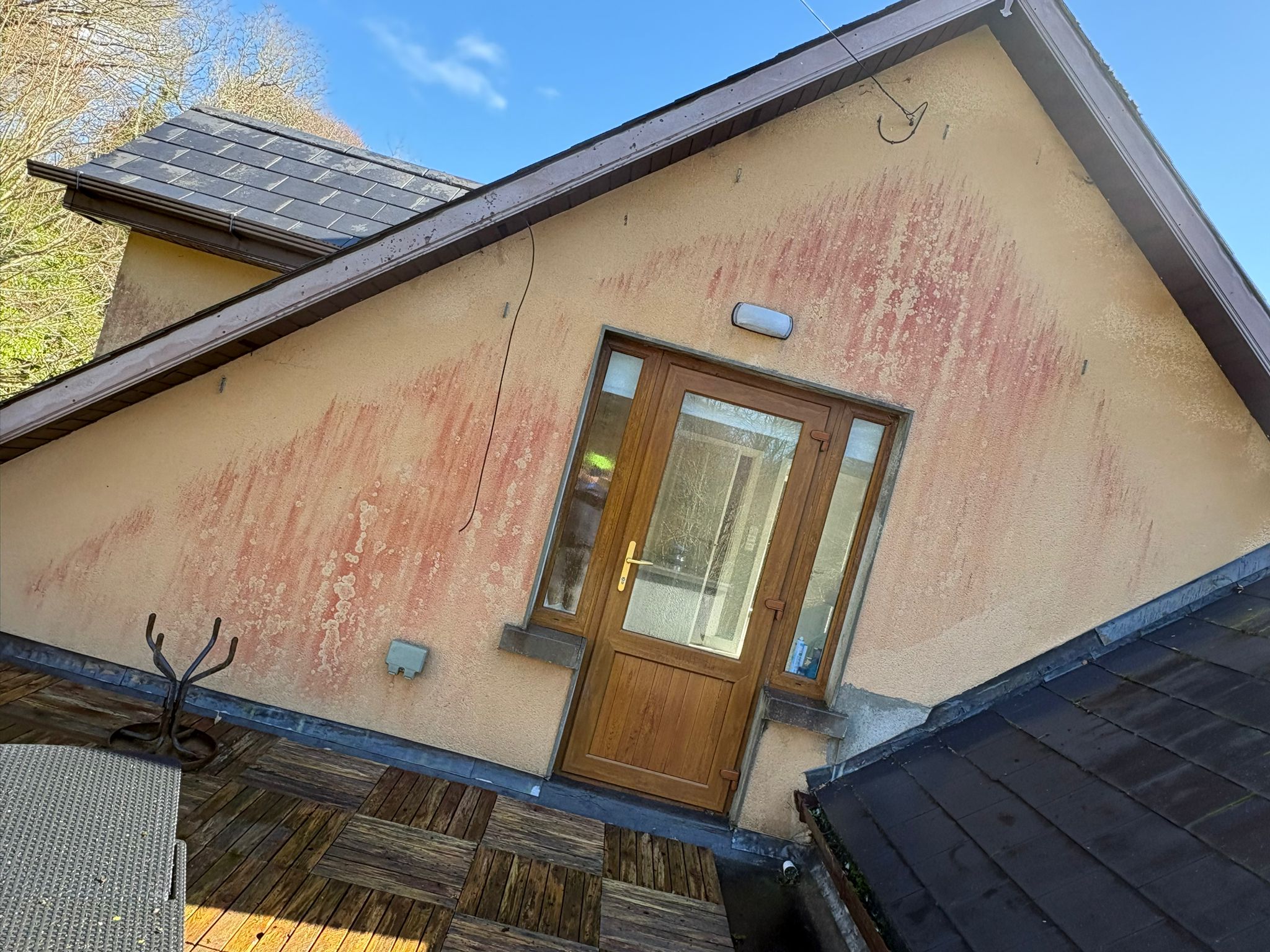 Stained tile roof before professional cleaning